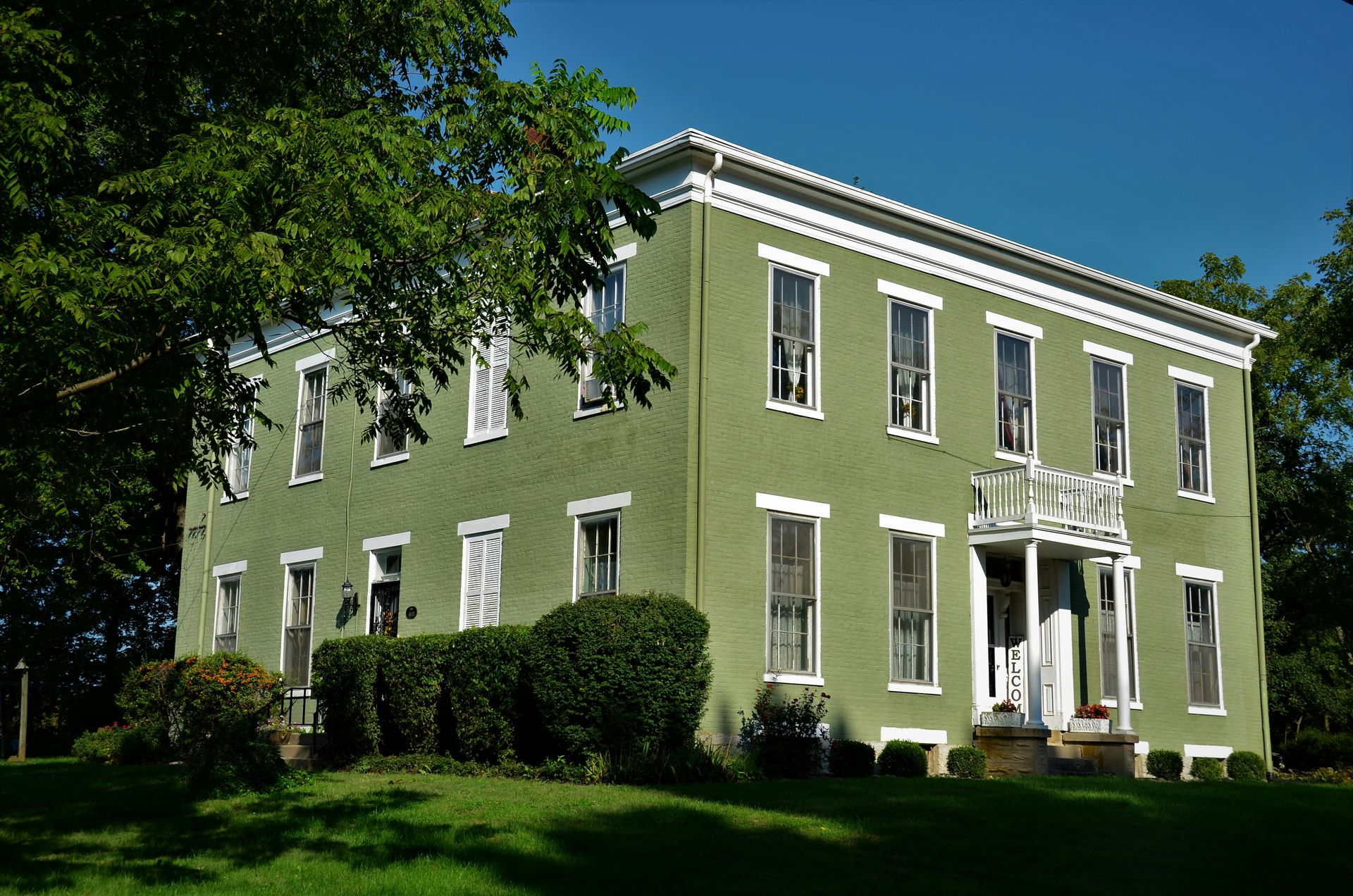 white concrete building near green grass field during daytime